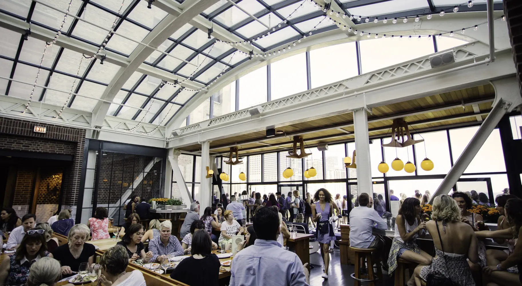 シンディのルーフトップバーのガラス張りのアトリウムの下に人だかりができる